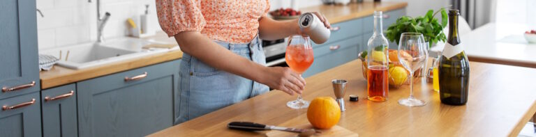 woman making mixed drinks in kitchen